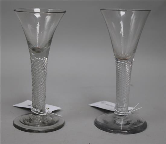 A near pair of ale glasses, c.1750, with flared bowls over air twist stems, 6in.